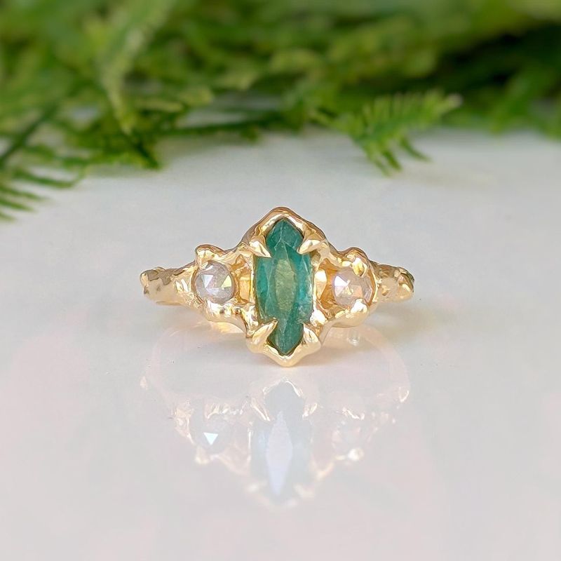 Emerald and diamond engagement ring